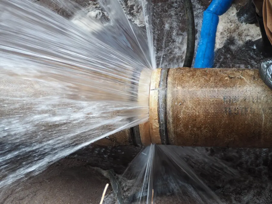 Water spraying from a burst copper pipe in a Big Lake, MN home